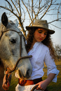 Young woman wearing hat on field