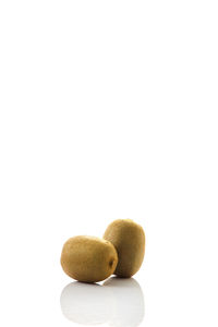 Close-up of kiwi over white background