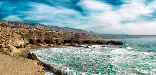 Scenic view of sea against cloudy sky