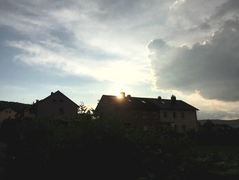 Buildings against cloudy sky