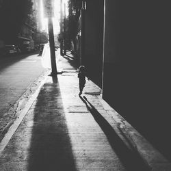 Woman walking on road in city