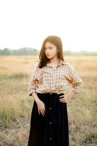 Portrait of woman standing on field