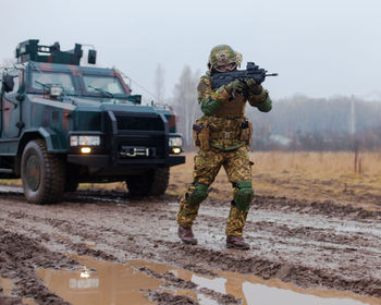 Soldier patrolling with a machine gun