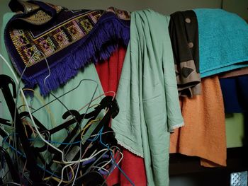 Close up of multi-colored clothes hanging on the banister of the house
