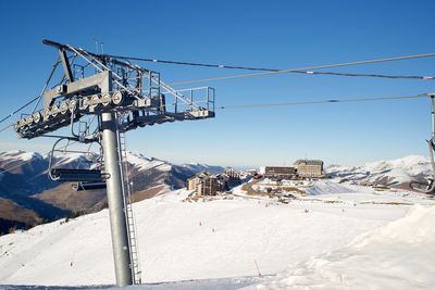 Ski lift against clear sky during winter