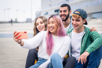 Portrait of smiling young man using mobile phone