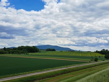 Scenic view of agricultural field and sleza mountain against sky in poland.