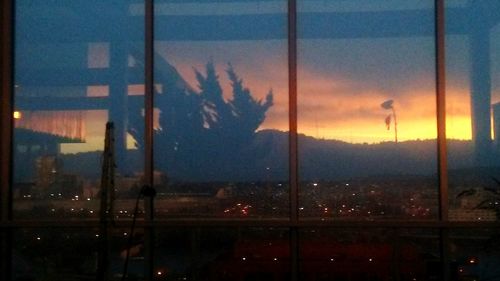 Silhouette of cityscape against sky during sunset