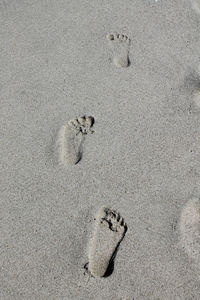 High angle view of footprints on sand