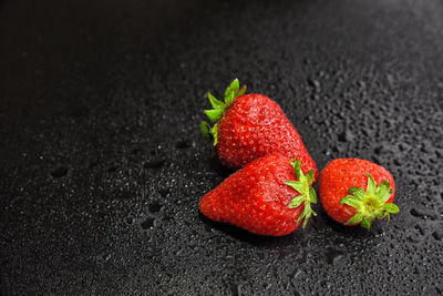 Close-up of strawberry over black background