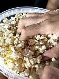 Close-up of hand holding bowl of food