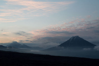 Scenic view of silhouette mountains against sky at sunset