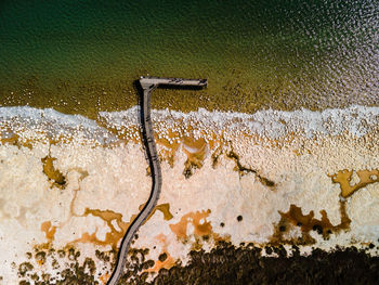 High angle view of water drops on rusty metal