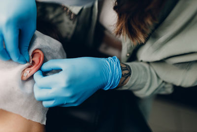 Midsection of doctor examining patient