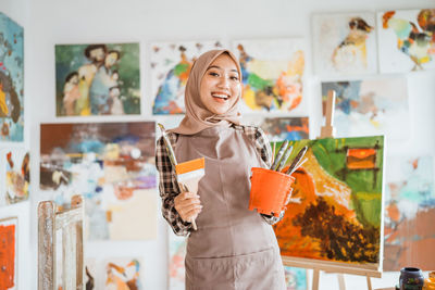 Portrait of young woman holding gift