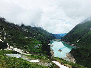 Scenic view of lake and mountains against sky