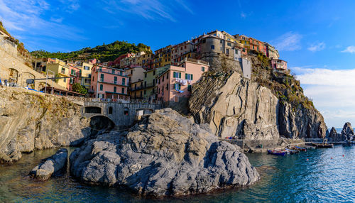 Panoramic view of sea and buildings against sky