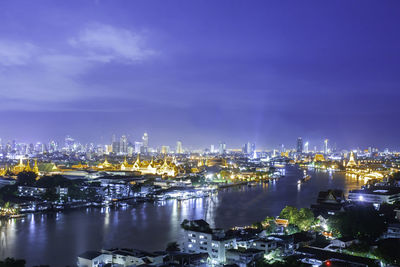 High angle view of illuminated buildings against sky at night