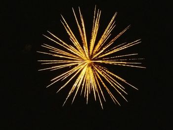 Low angle view of firework display at night