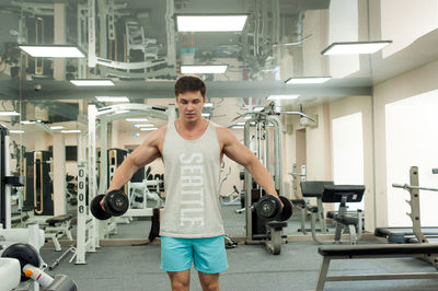 Young man exercising in gym