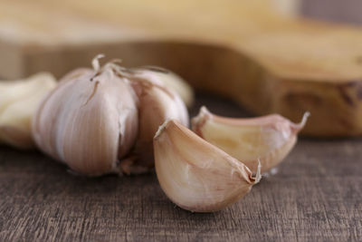 Close-up of garlics on wooden table