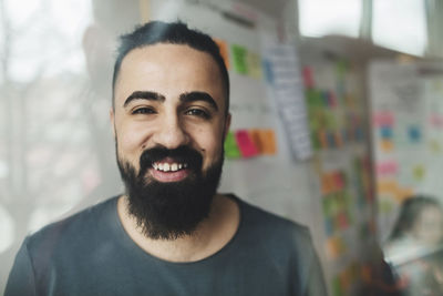 Portrait of smiling businessman in creative office