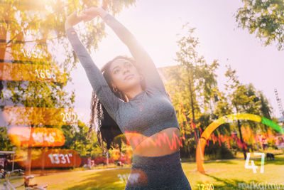 Portrait of woman standing against trees