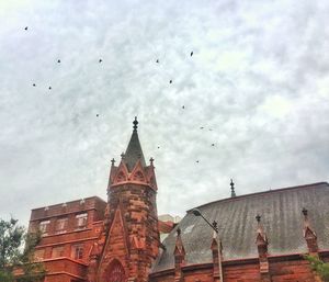 Low angle view of cathedral against cloudy sky