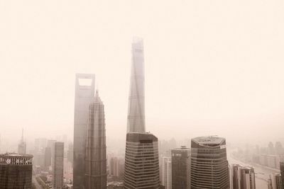 View of skyscrapers in foggy weather