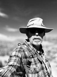 Portrait of man wearing hat against sky