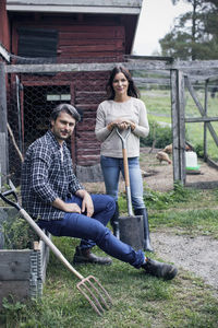 Portrait of couple at poultry farm