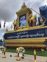 Low angle view of statue against building against sky