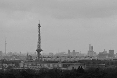 Tower in city against sky