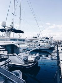 Sailboats moored on harbor