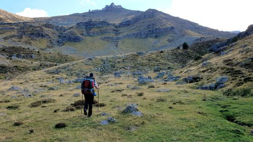 Rear view of men walking on mountain road