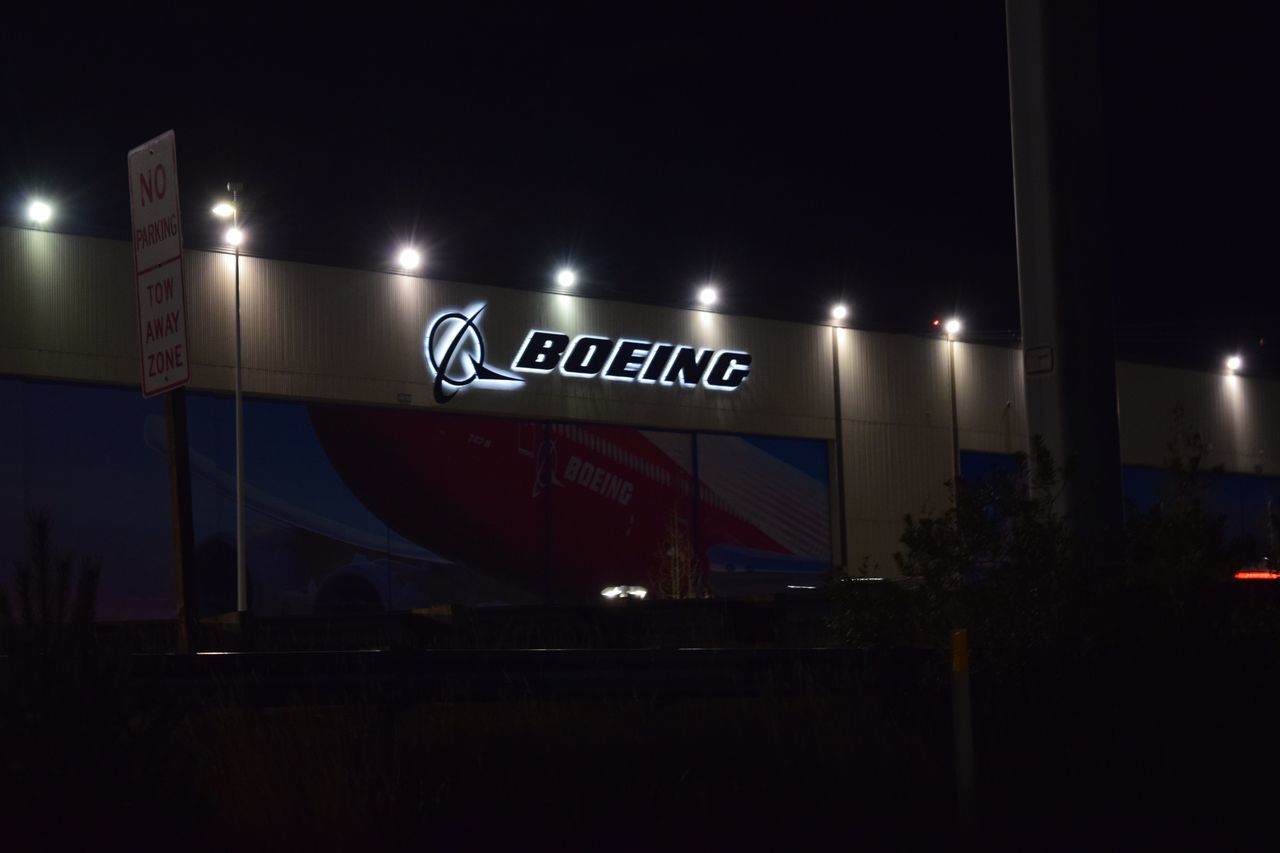 illuminated, western script, text, communication, night, sign, information, information sign, no people, capital letter, transportation, lighting equipment, architecture, outdoors, guidance, blurred motion, sky, script, copy space, mode of transportation