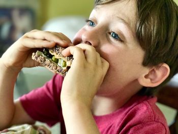 Close-up portrait of boy eating food