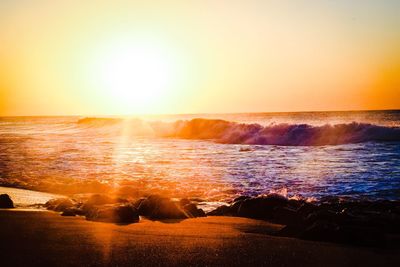 Scenic view of sea against clear sky during sunset