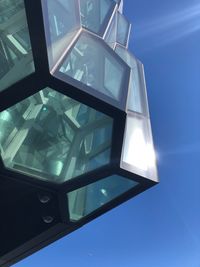 Low angle view of illuminated building against blue sky