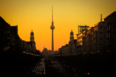 Buildings in city against sky during sunset