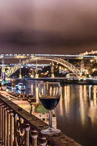 Close-up of illuminated bridge over river against sky at night