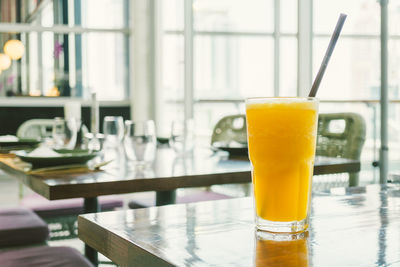 Close-up of orange juice on table