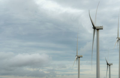 Low angle view of electricity pylon against sky