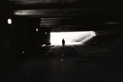 Rear view of silhouette man walking in subway