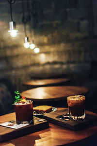 Illuminated tea light candles on table in restaurant