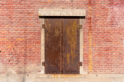 Close-up of brick wall with closed door