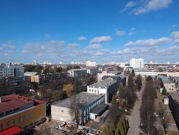 High angle view of buildings against blue sky