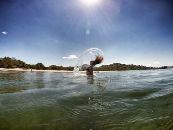 Woman splashing water in sea