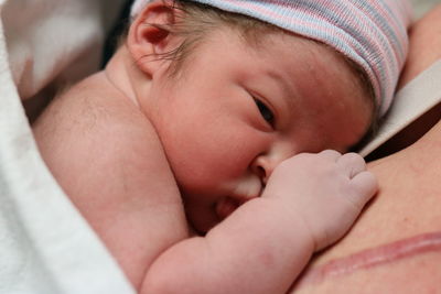 Close-up of baby sleeping on bed