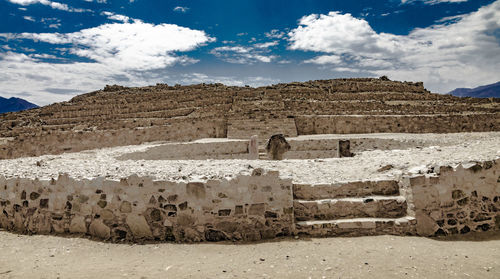 View of old ruins against cloudy sky in caral